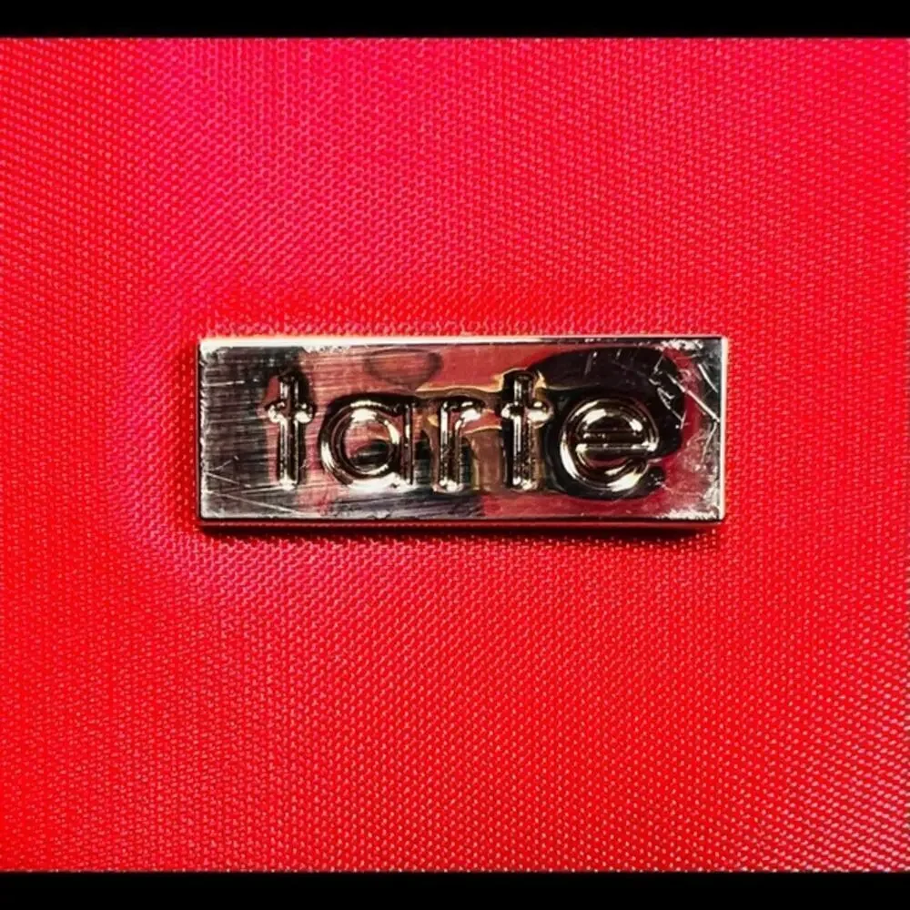 Tarte red cosmetic bag/ clutch, nice size with beautiful purple satin interior
